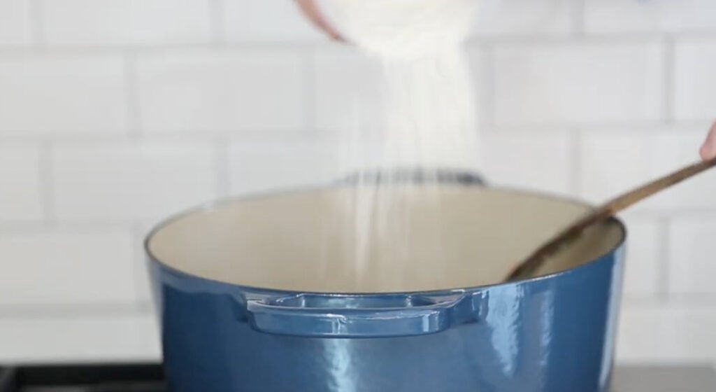 adding the flour to the pot