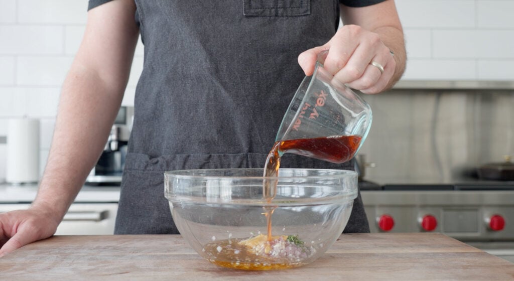 adding red wine into bowl with other ingredients