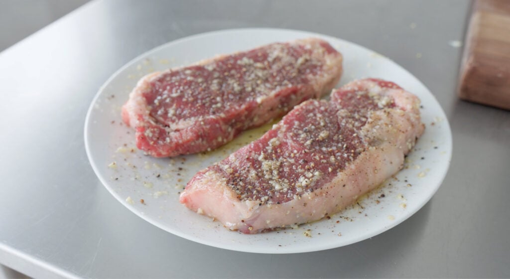 Seasoned steaks on a plate