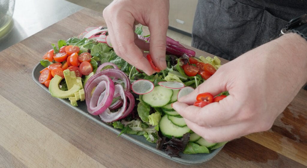 steak salad being arranged