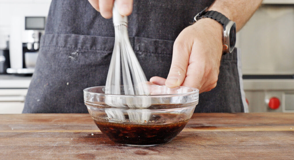 whisking sauce ingredients in a bowl