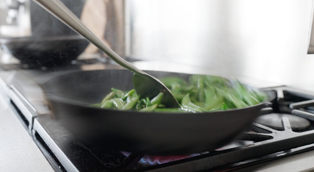 Stir frying Peas in a skillet