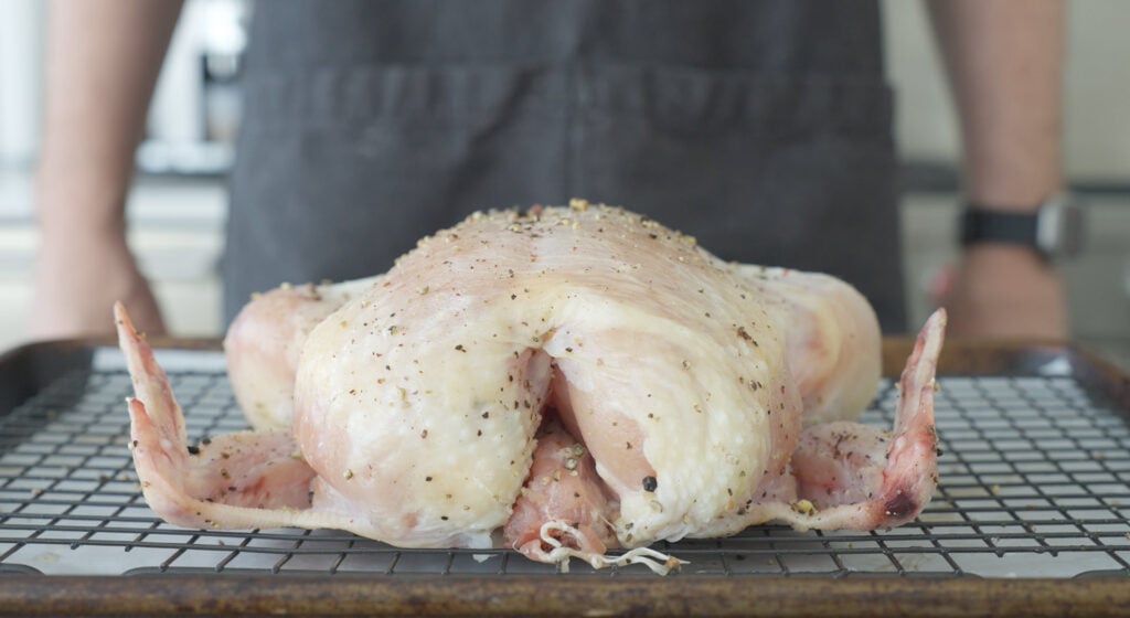 side view of seasoned chicken ready to be cooked