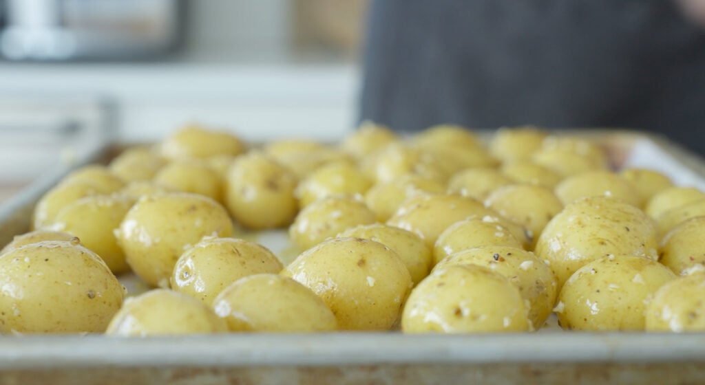 Baby potatoes arranged on a sheet tray