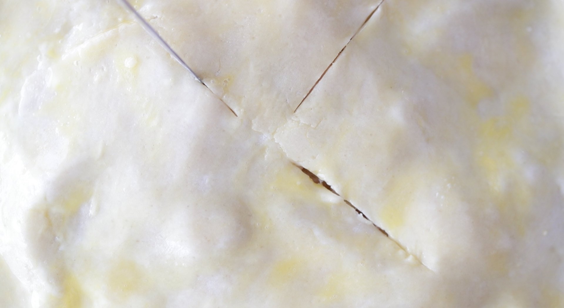 cutting slits into the apple pie