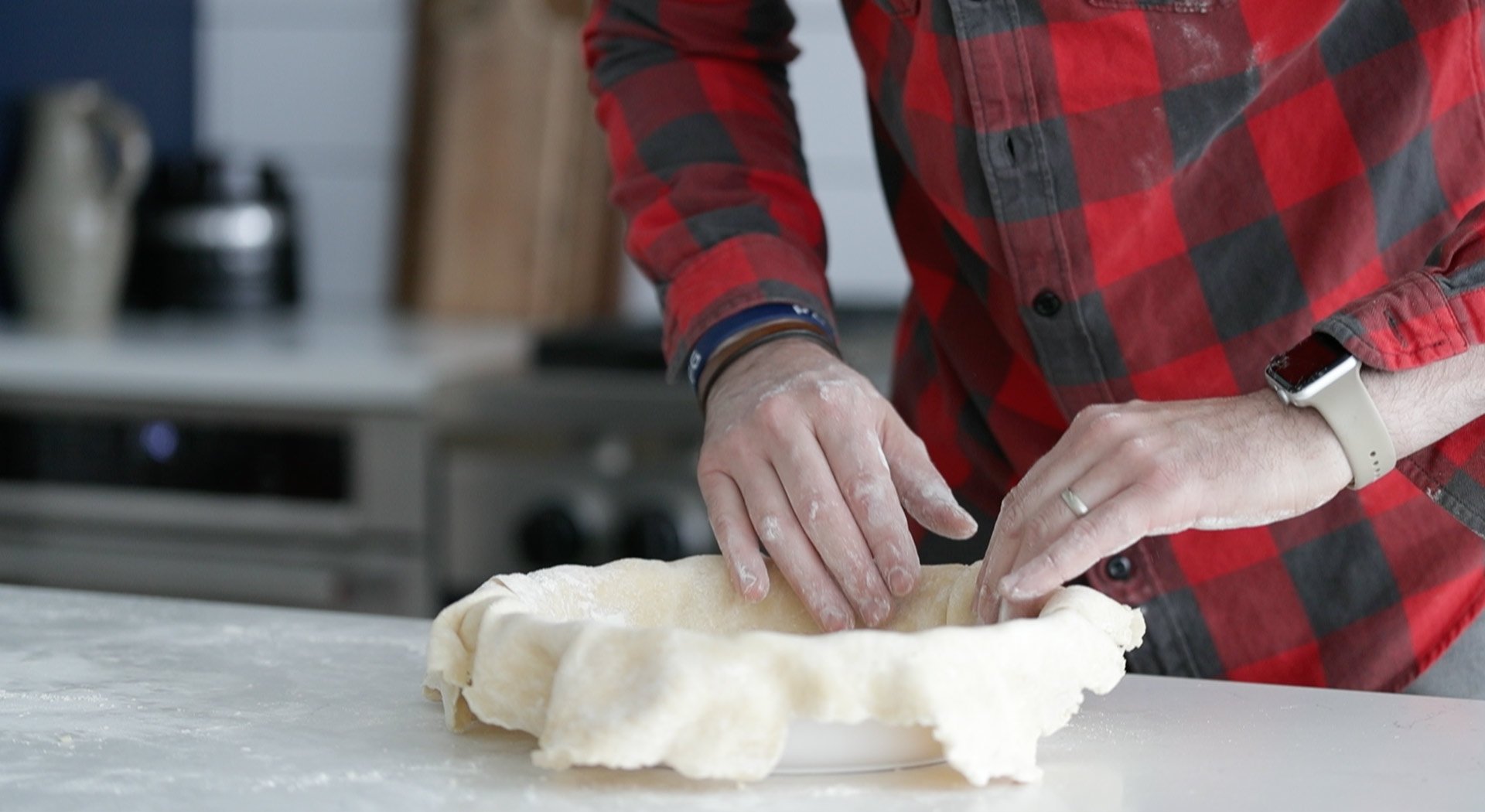 adding dough to a pie pan