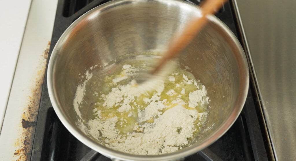stirring the roux in a pan