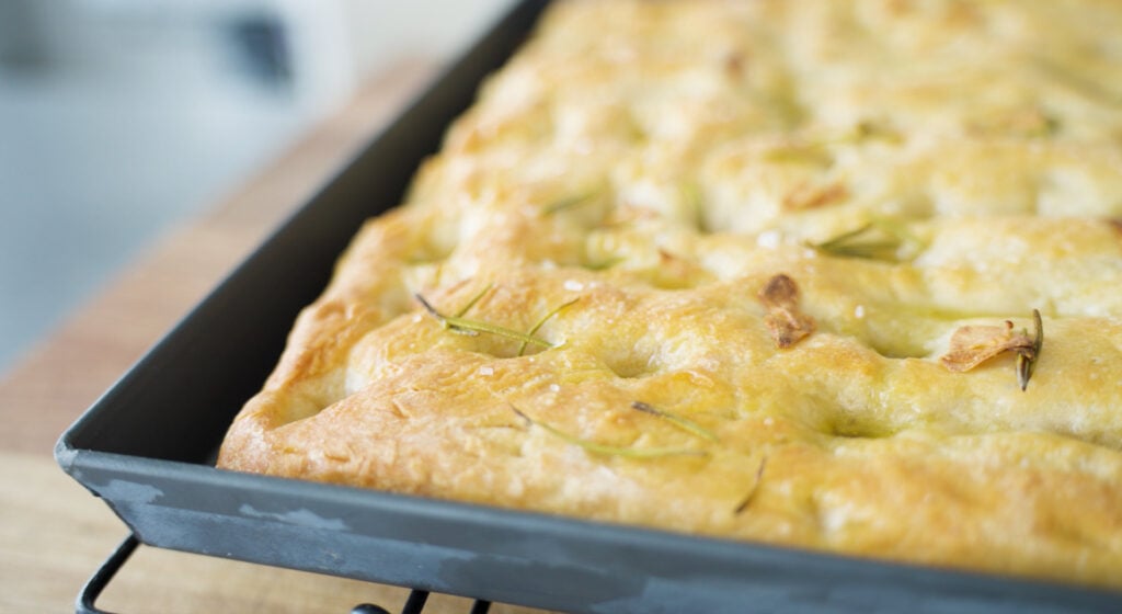 Cooked, browned focaccia in pan