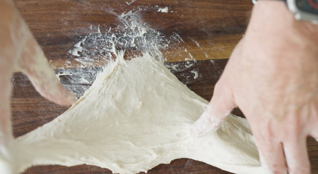 Dough being stretched and kneaded