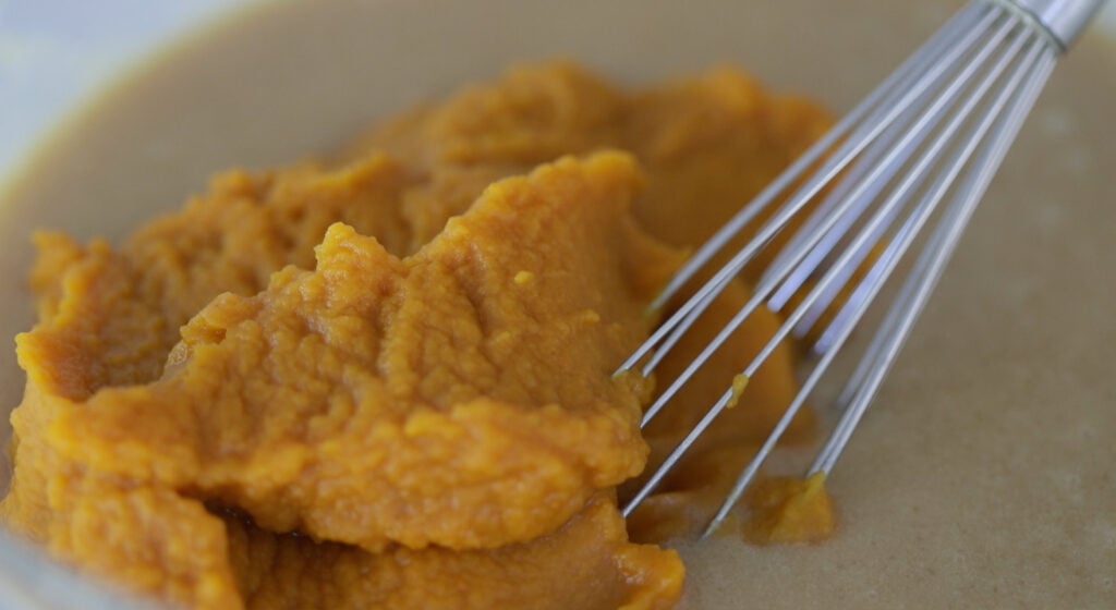 whisking pumpkin puree with batter