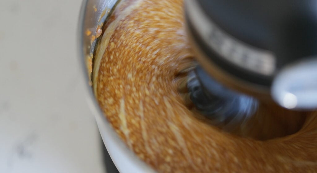 mixing eggs, both sugars, pumpkin puree, melted butter, and rum