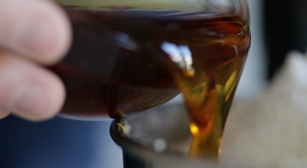 poring maple syrup into a bowl