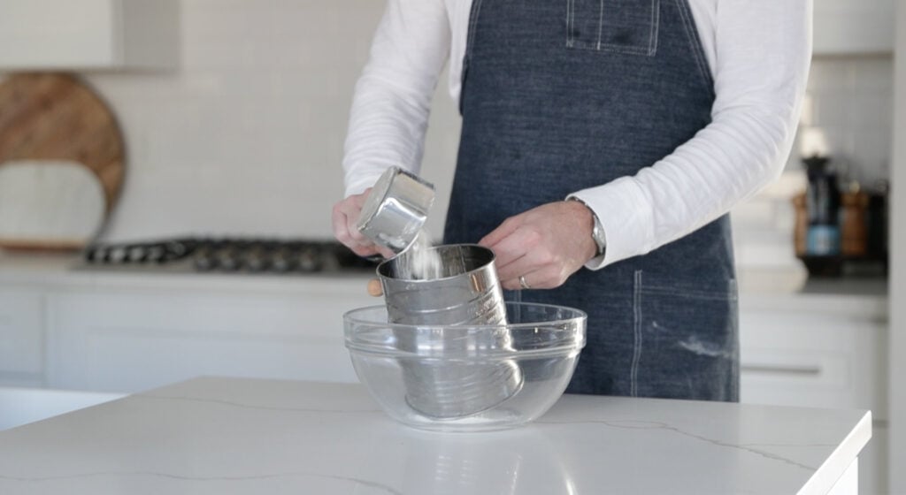 sifting together flour and sugar