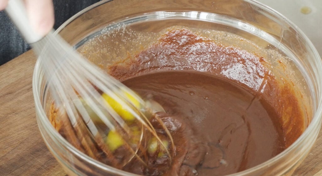 whisking eggs into chocolate mixture