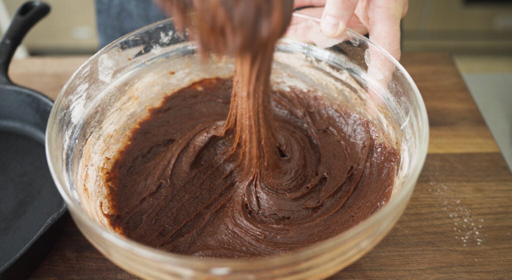 Stirring brownie batter in bowl