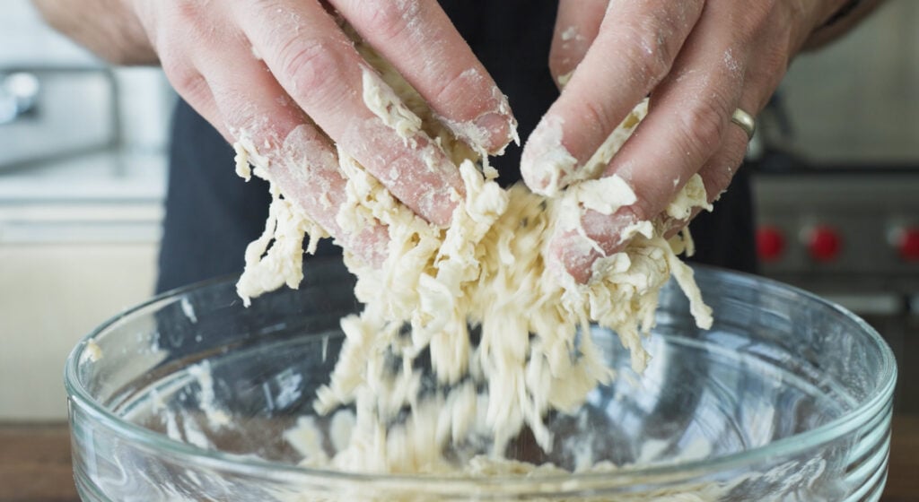 mixing biga ingredients by hand