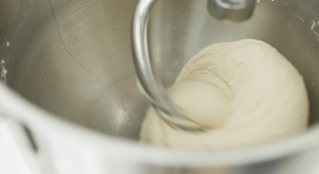 dough on dough hook in mixing bowl