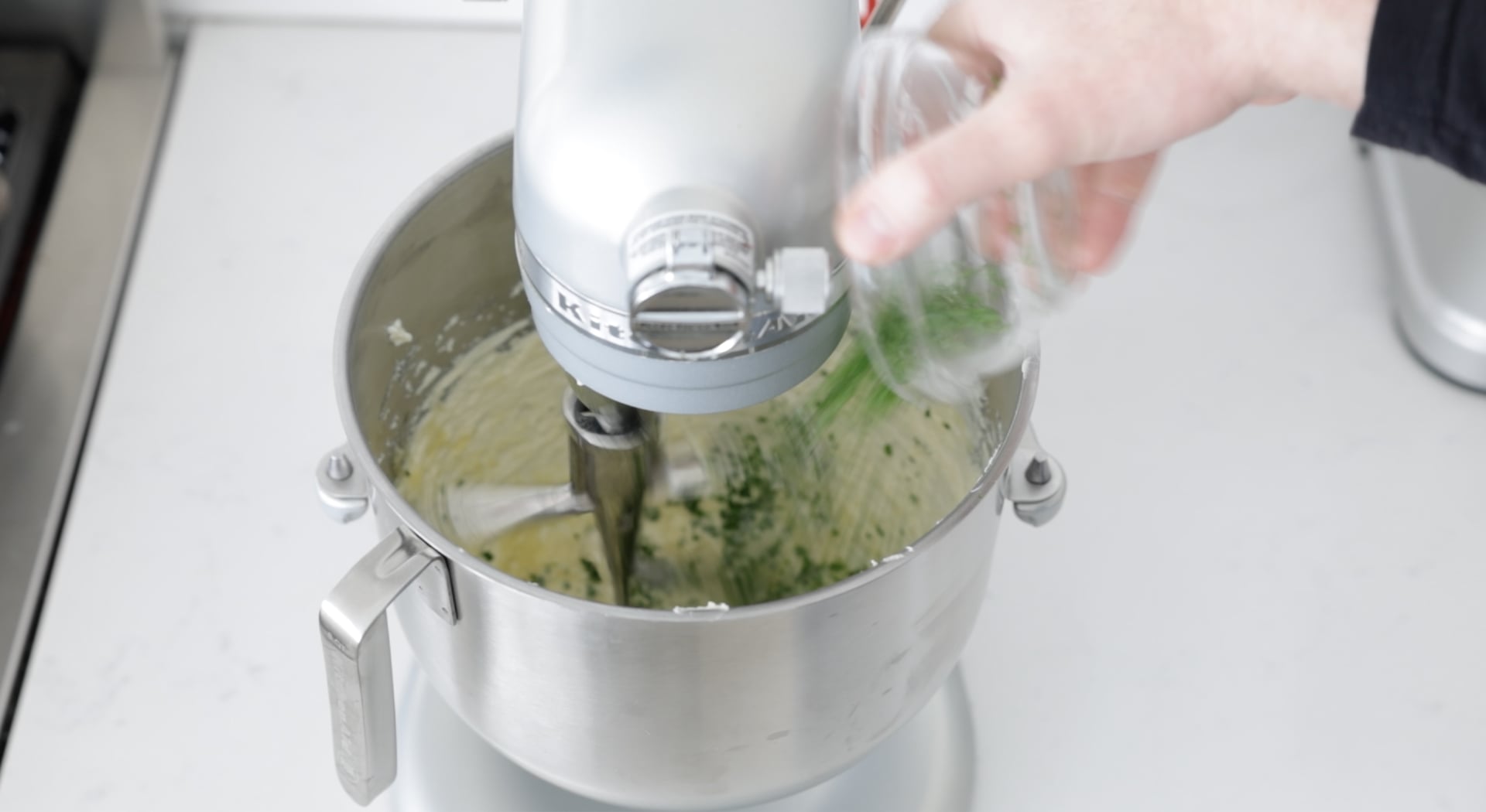 adding herbs to whipped butter