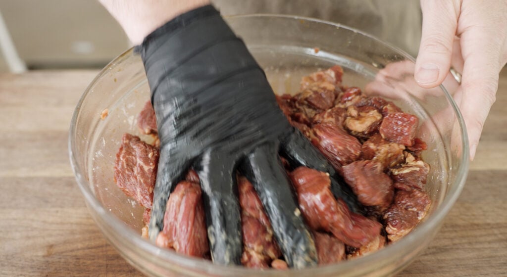 mixing meet with marinade ingredients