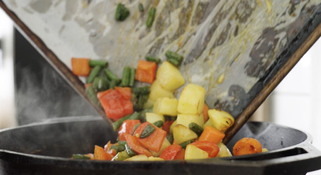 adding vegetables to the pot