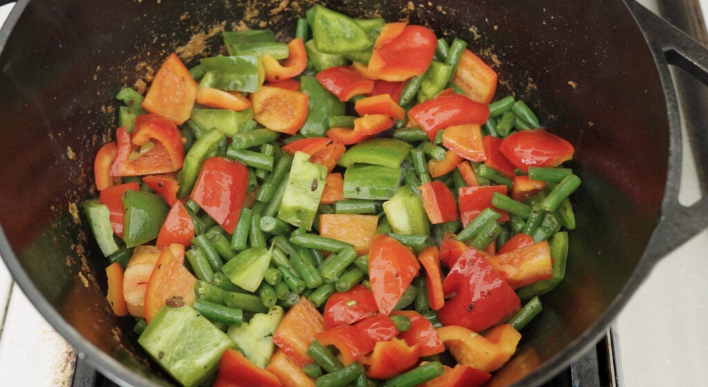 bell peppers and beans in cast iron pot