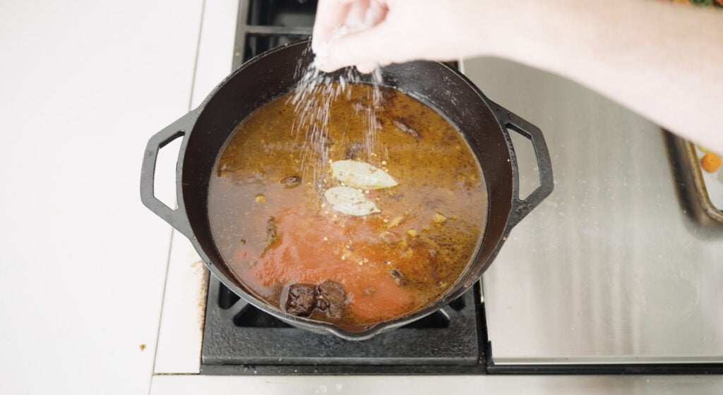 seasoning the kaldereta with salt