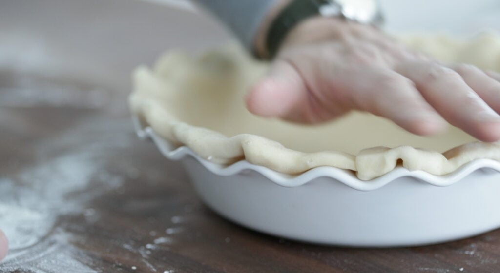 forming a pie crust to a pie tin