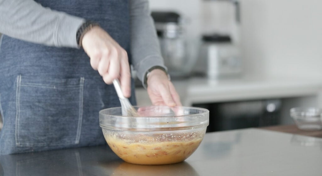 mixing pecans into a pecan pie filling
