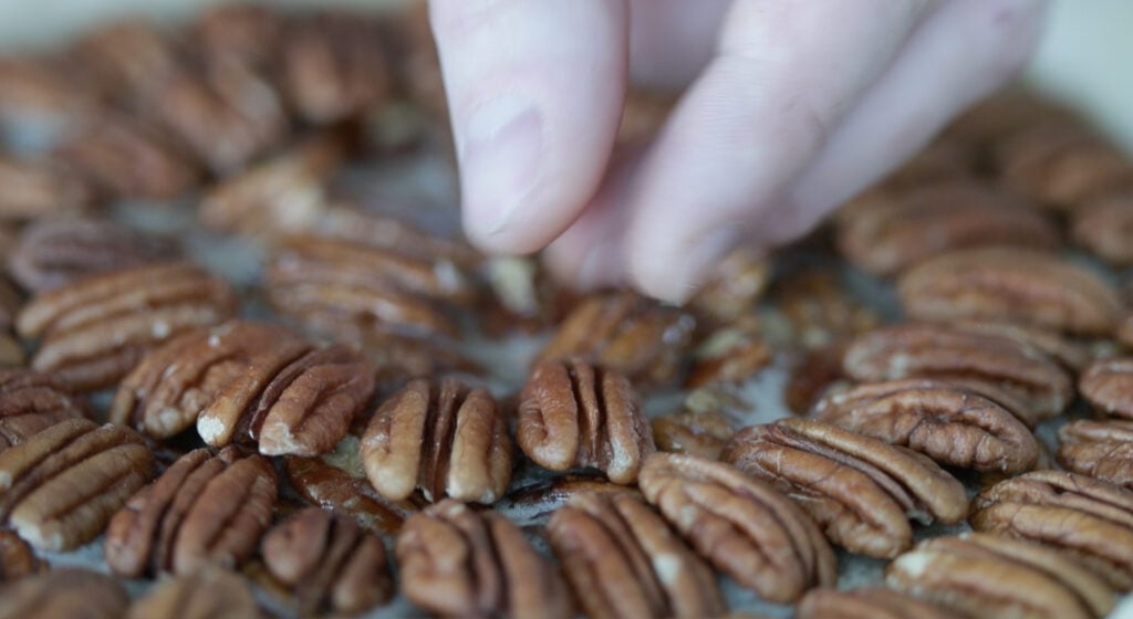 adding pecans to a pecan pie