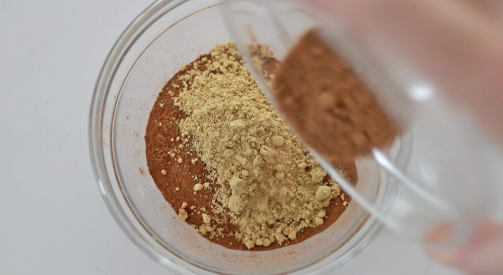 adding spices to a bowl