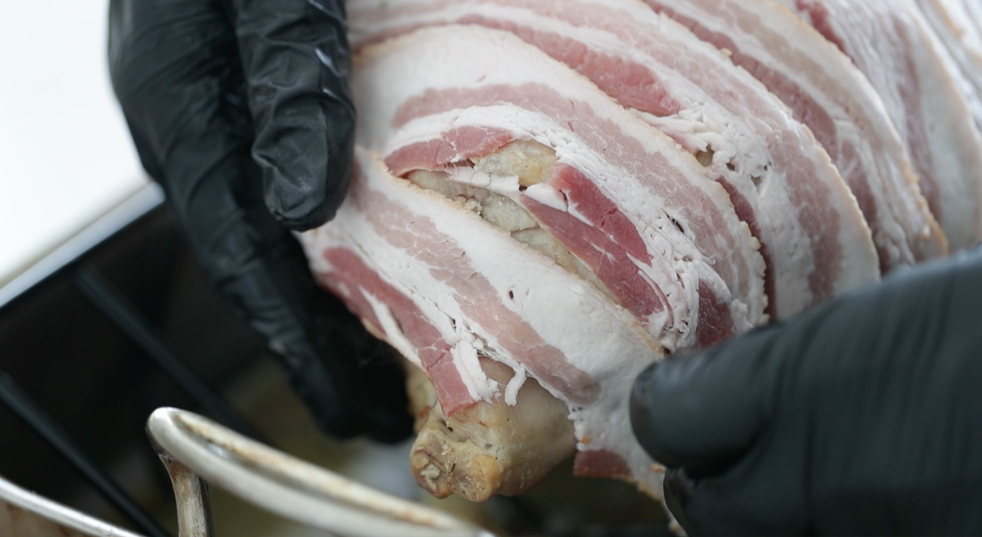 covering a turkey with strips of bacon