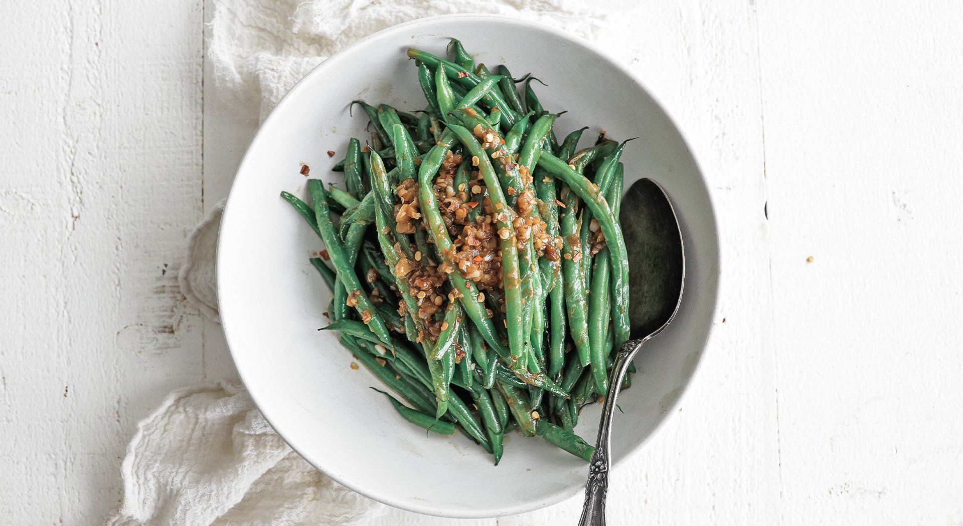green beans in a bowl with shallots