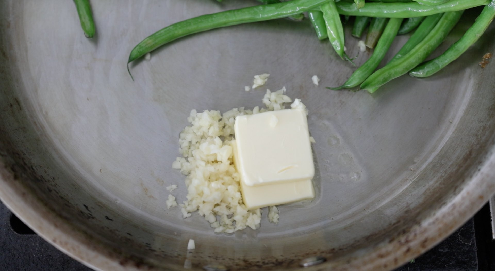 adding butter and garlic to a pan