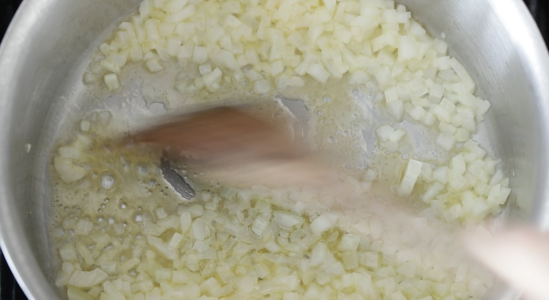 sautéing onions in a pan