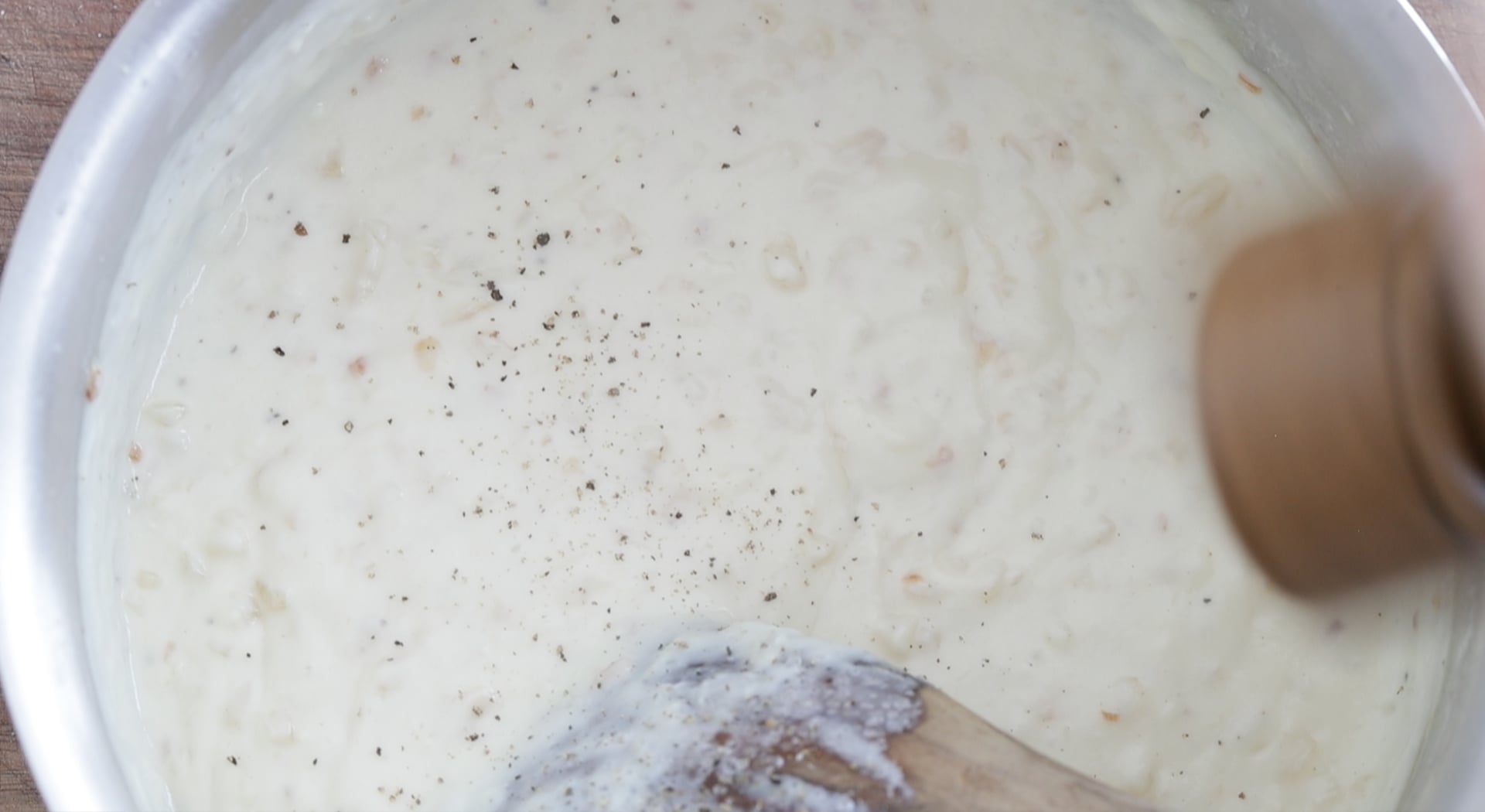 mixing together seasoning into a cream sauce