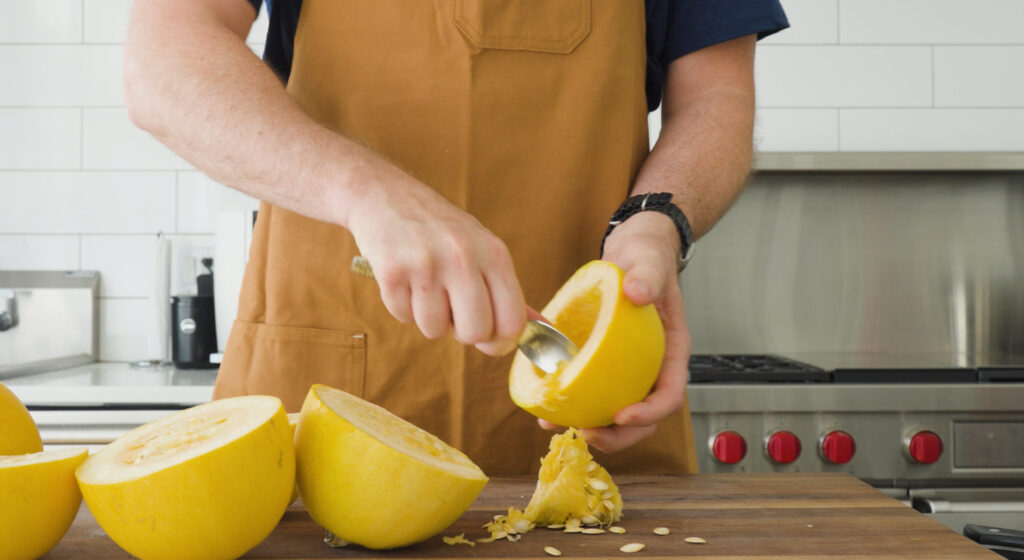 Scooping seeds out of squash