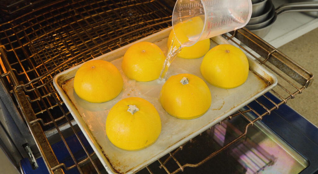 Pouring water on pan with squash
