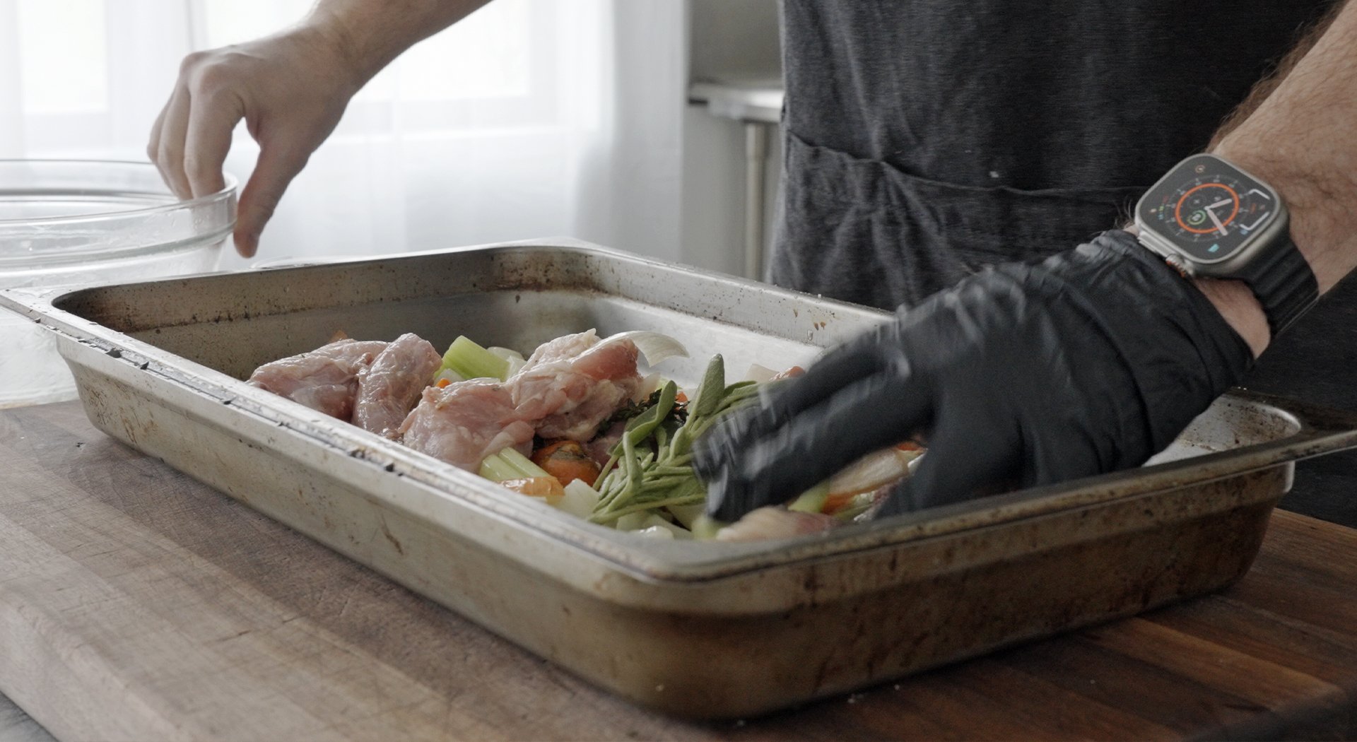 adding veggies to a roasting pan