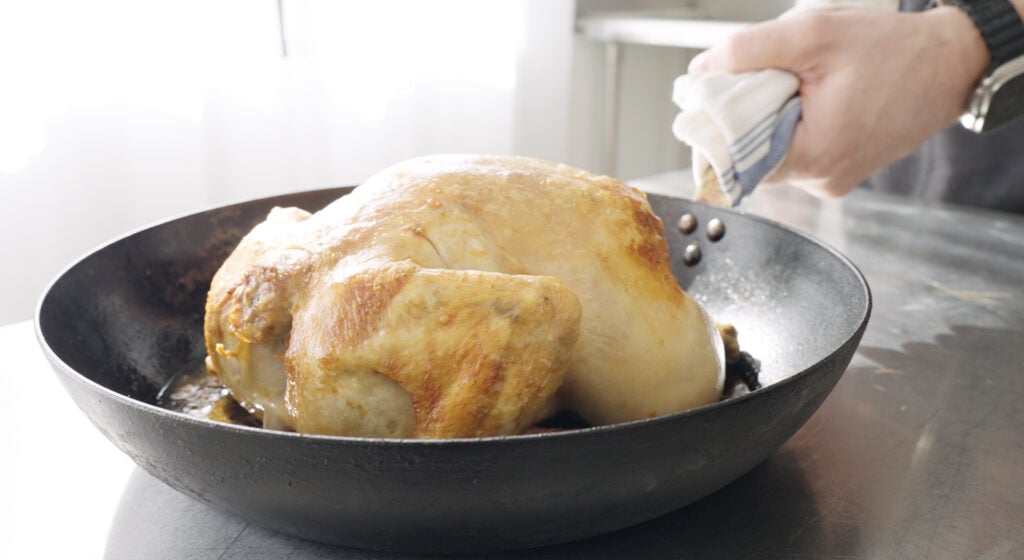 browned whole chicken in a skillet