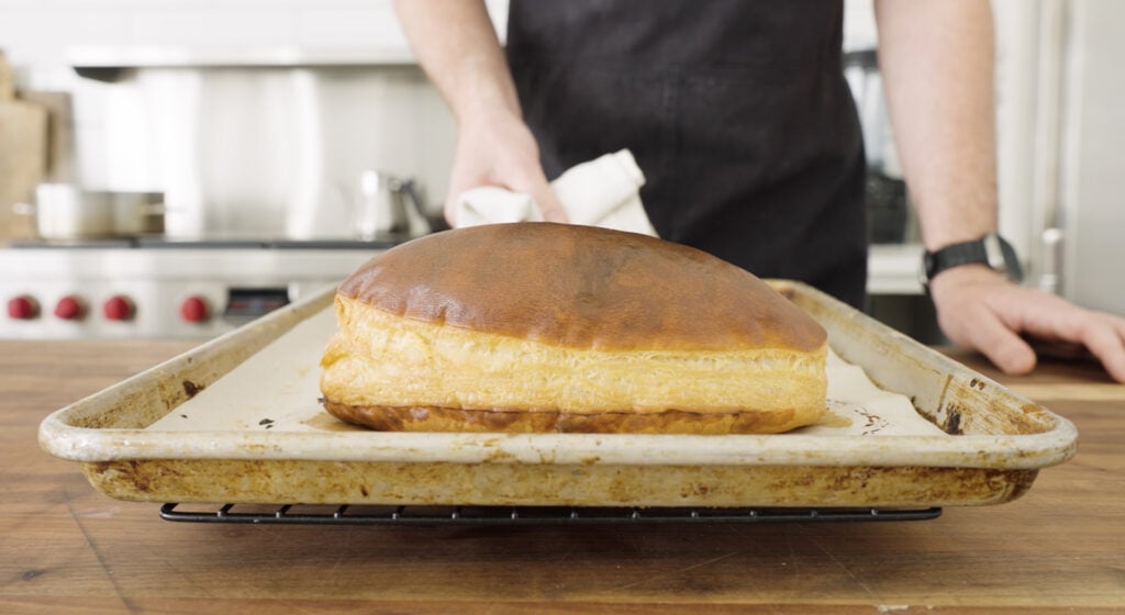 Cooked, golden brown puff pastry on a tray