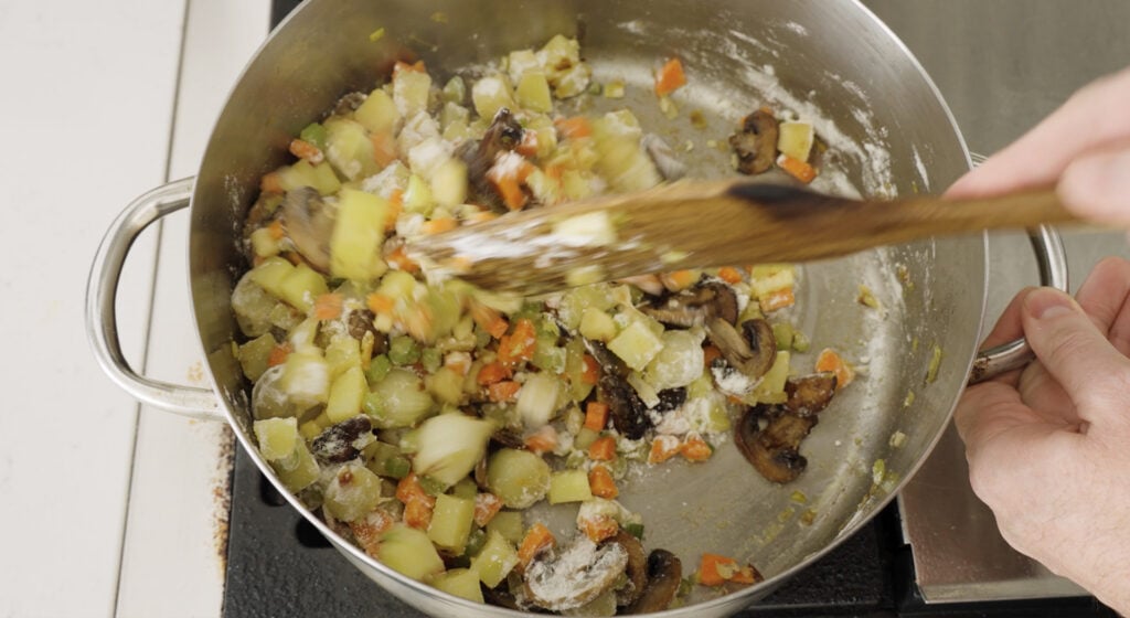 stirring flour into ingredients in pot to make roux