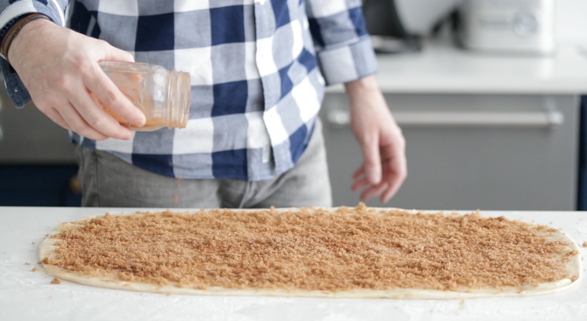 adding cinnamon, sugar, and, butter to dough