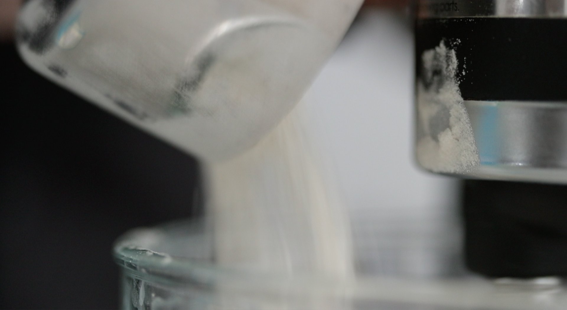 adding flour to a stand mixer