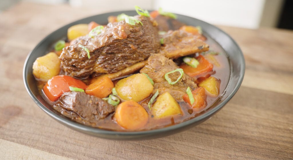 Finished Beef Mechado in a serving dish on a table