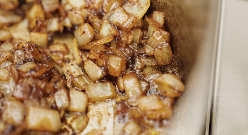 close up of browned onions and garlic in pot