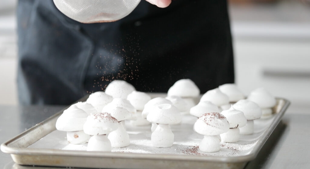 dust the tops of the mushrooms with cocoa powder.