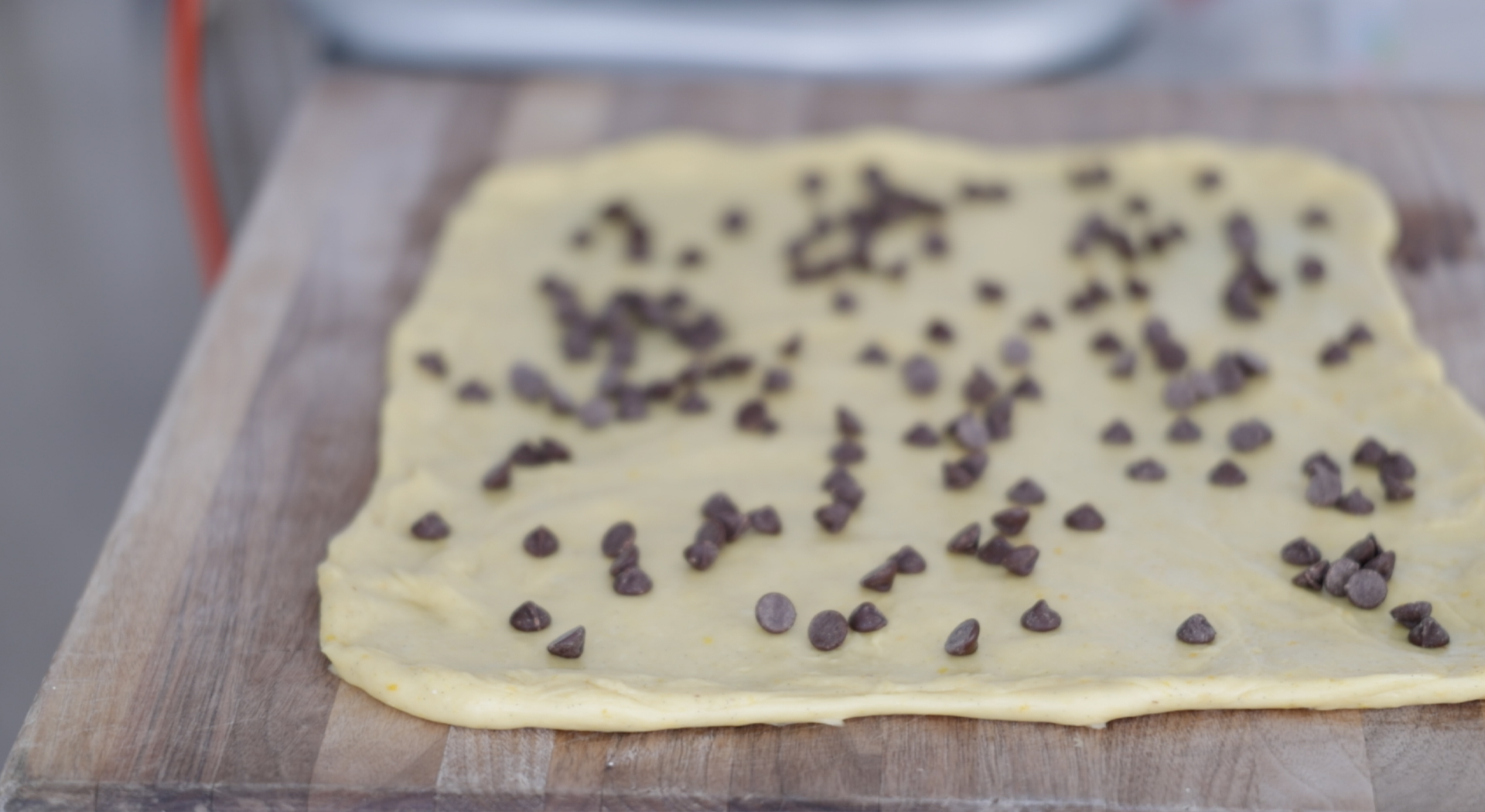adding chocolate chips to dough