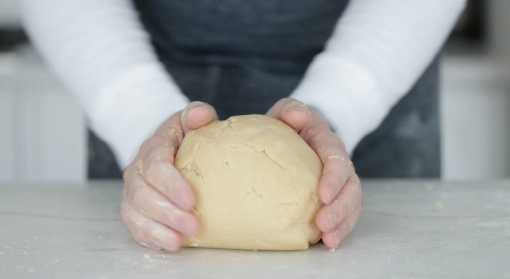 kneading cookie dough on a countertop