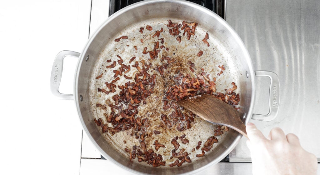 Crispy bacon lardons in rondeau pot