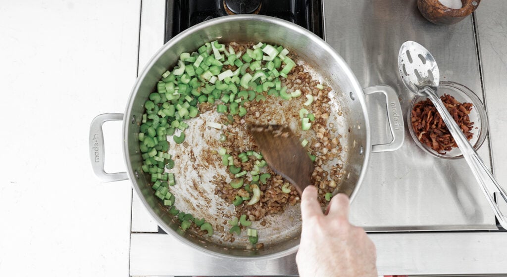Stiring shallots and cellery in pot 